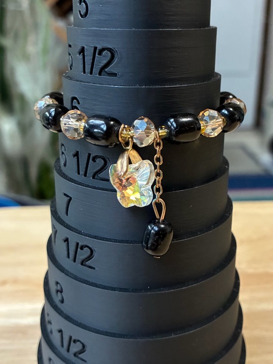 Jewelry - Black and Gold Beaded Stretch Bracelet with Iridescent Flower Charm